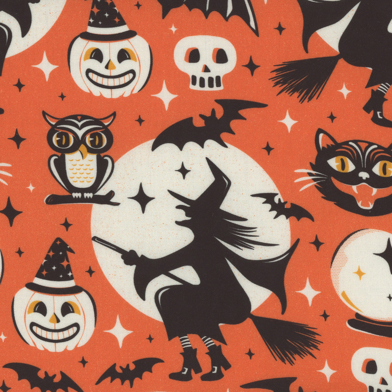 speckled orange fabric with witch silhouettes flying in front of a full moon, 4-pointed stars, skulls, owls, bats, jack o' lanterns, black cat faces, and crystal balls