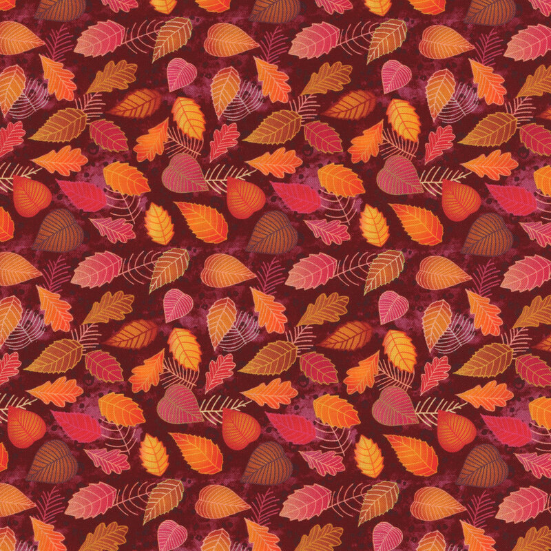 fabric with various leaves in shades of green, orange, red, and brown on a dark red background