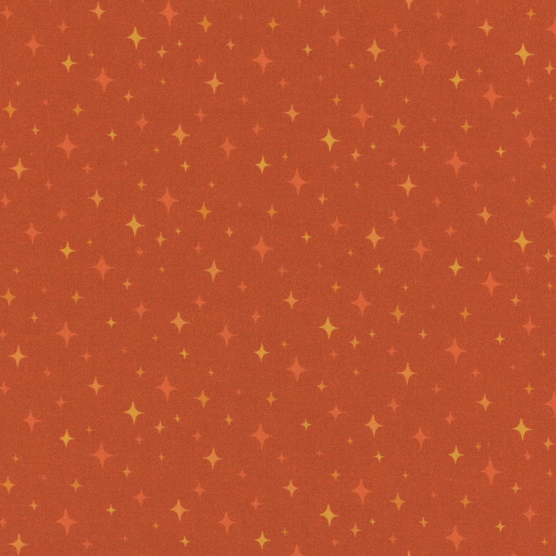 speckled orange fabric with scattered tonal 4-pointed stars
