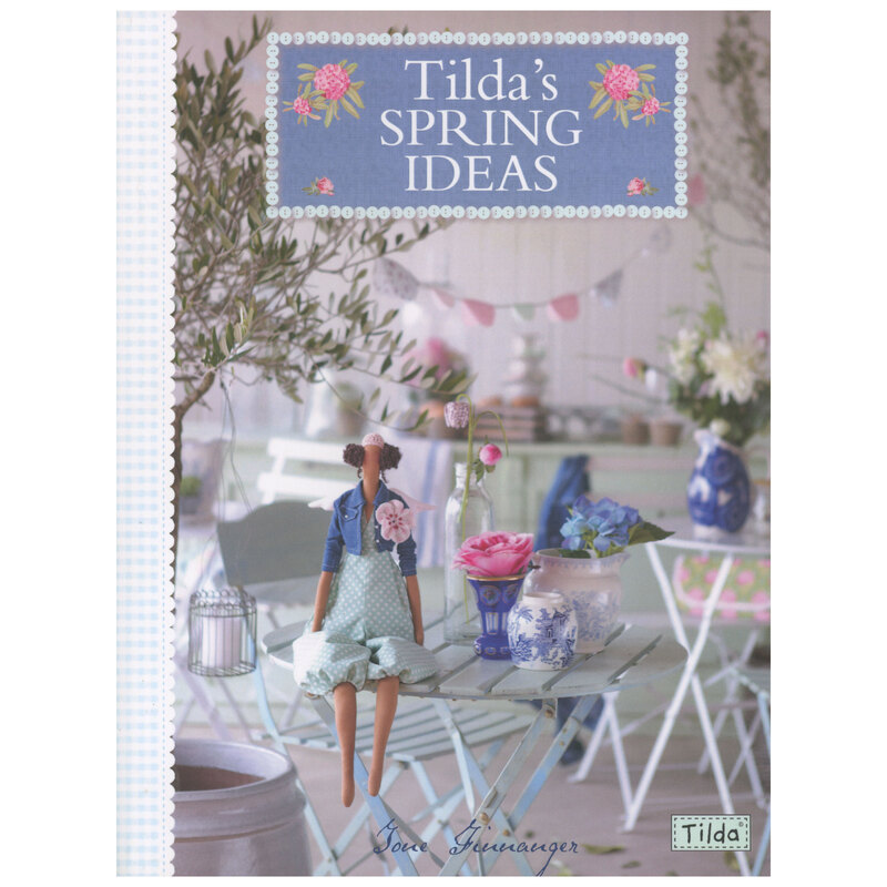 Front cover of book featuring an adorable doll staged on a vintage terrace table 