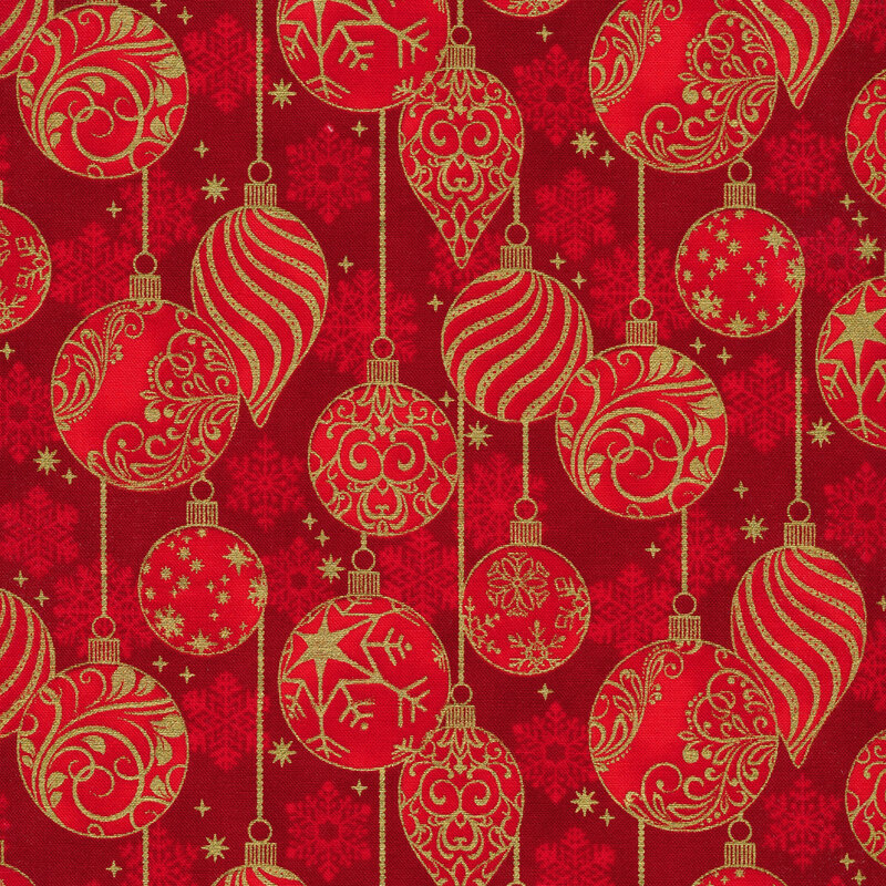 rich red fabric featuring scattered bright red snowflakes overlaid by metallic gold Christmas ornaments