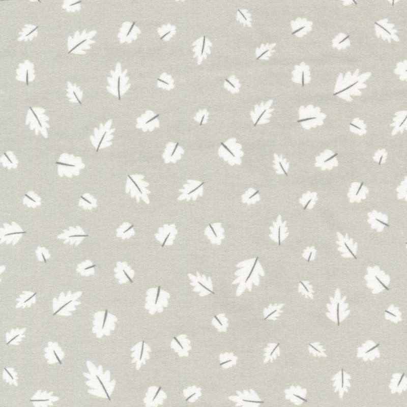 light gray flannel fabric featuring scattered white leaves