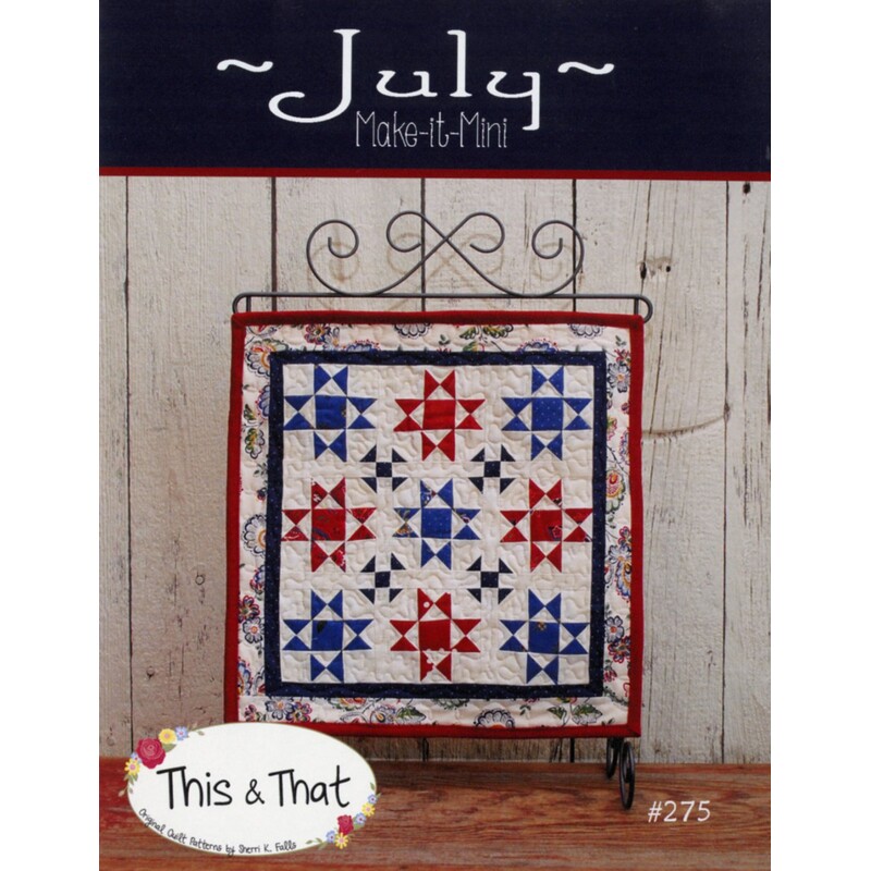 Front cover of pattern, showing the finished wallhanging hung from a craft scroll, staged in front of wood panels