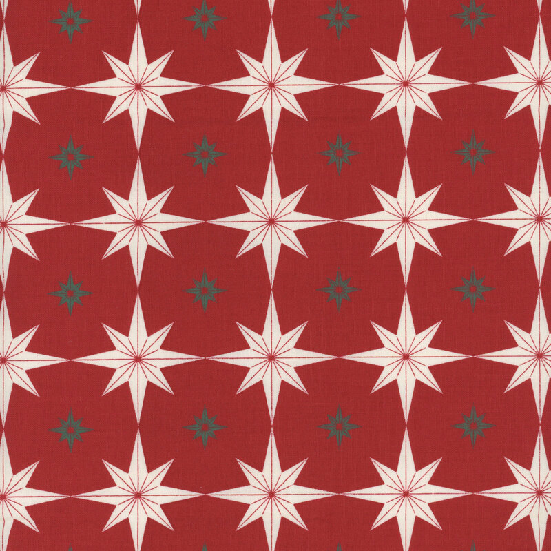 Red fabric with large cream-colored stars and small green stars.