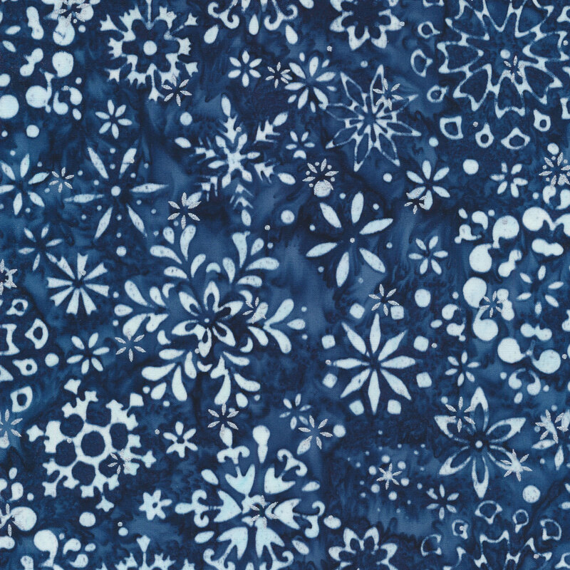 navy blue mottled fabric featuring various scattered white snowflakes and accented with metallic silver snowflakes