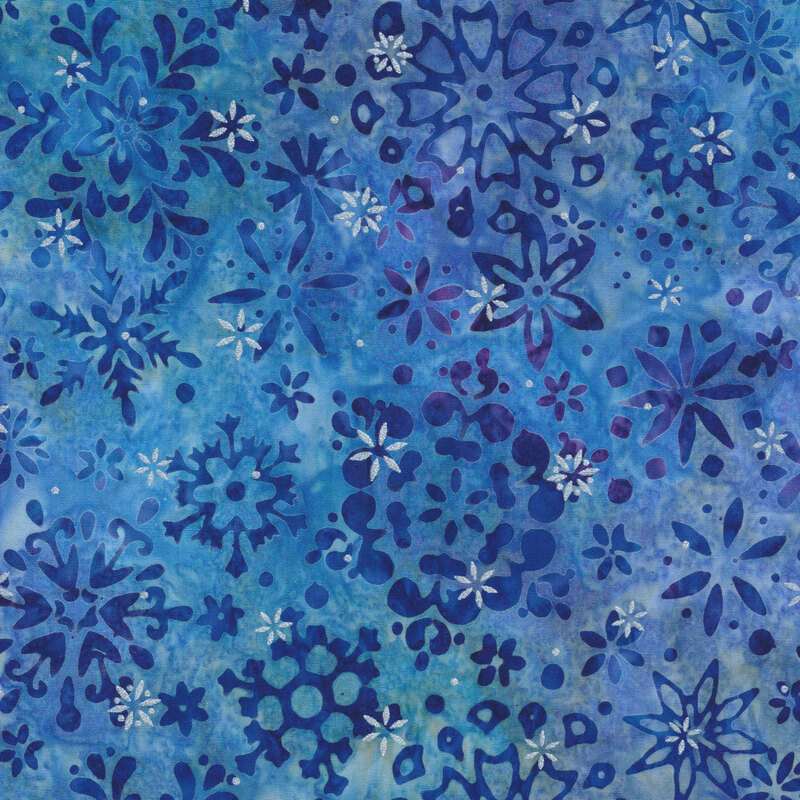 blue mottled fabric featuring various scattered dark blue snowflakes and accented with metallic silver snowflakes