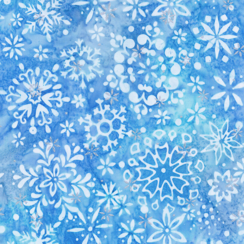 light blue mottled fabric featuring various scattered white snowflakes and accented with metallic silver snowflakes