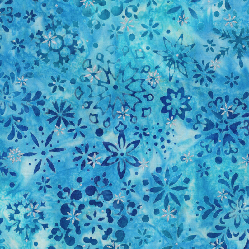 vivid blue mottled fabric featuring various scattered dark blue snowflakes and accented with metallic silver snowflakes