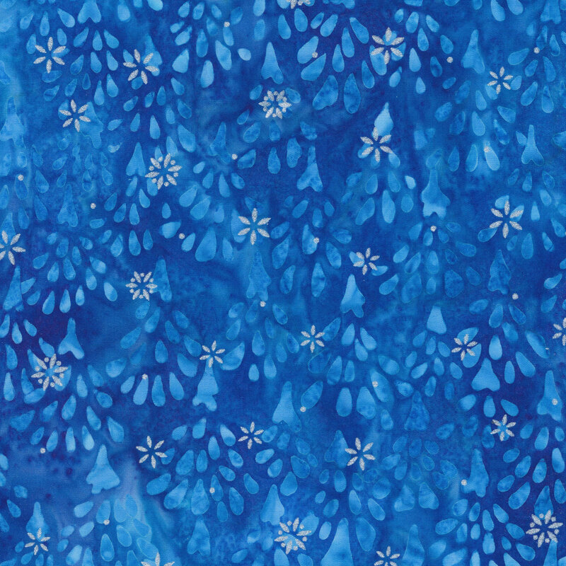 royal blue mottled fabric featuring impressionistic tonal fir trees, accented with metallic silver snowflakes