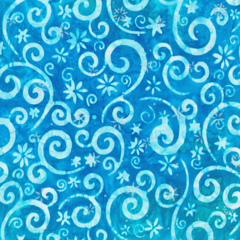 vivid blue mottled fabric featuring light blue swirling scrolls and snowflakes, accented with metallic silver snowflakes