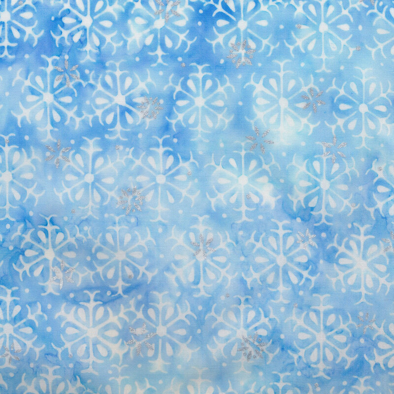 light blue mottled fabric featuring alternating rows of white snowflakes, accented with metallic silver snowflakes