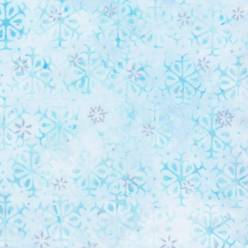 pastel blue mottled fabric featuring alternating rows of light blue snowflakes, accented with metallic silver snowflakes