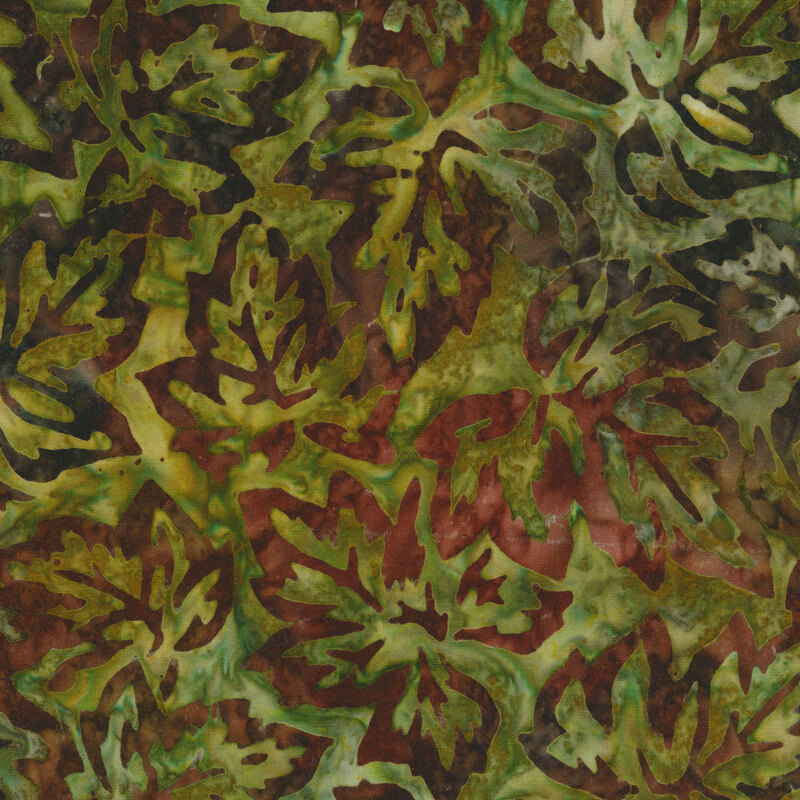 green mottled fabric featuring scattered leaf outlines in shades of mottled brown