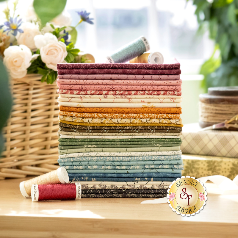A photo of a stack of colorful fabrics included in the Sewing Basket fabric collection