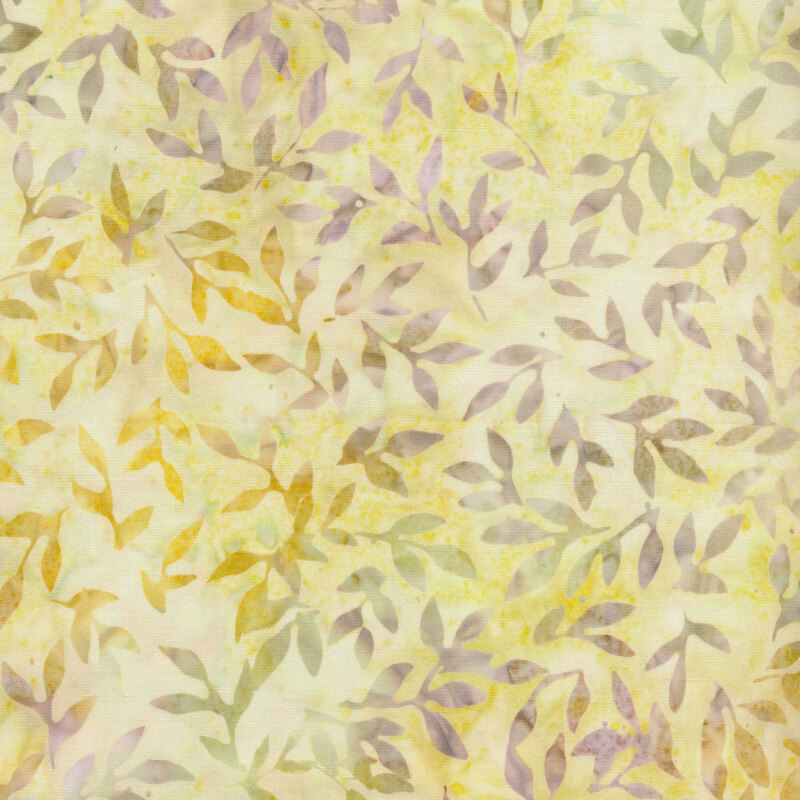 pale yellow mottled fabric featuring scattered leaves and vines in shades of mottled green, yellow, and light pink