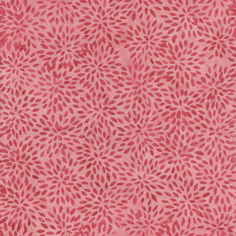 Mottled pink fabric with darker tonal tiny petal-like oval shapes in floral circular patterns