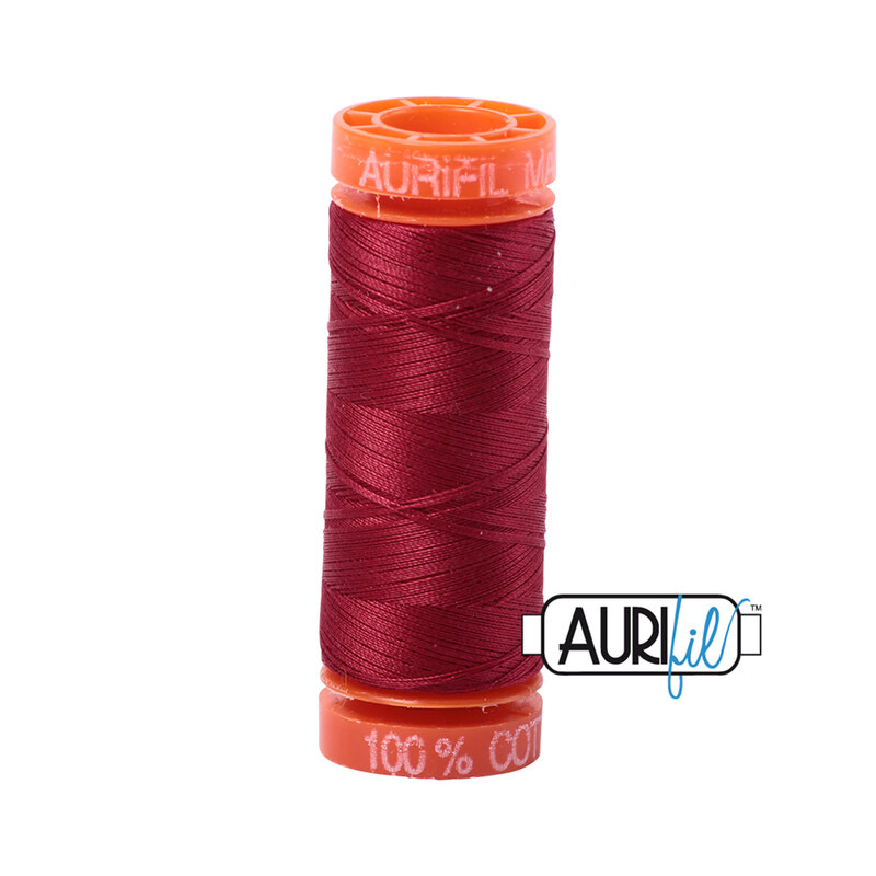 Burgundy thread on an orange spool, isolated on a white background