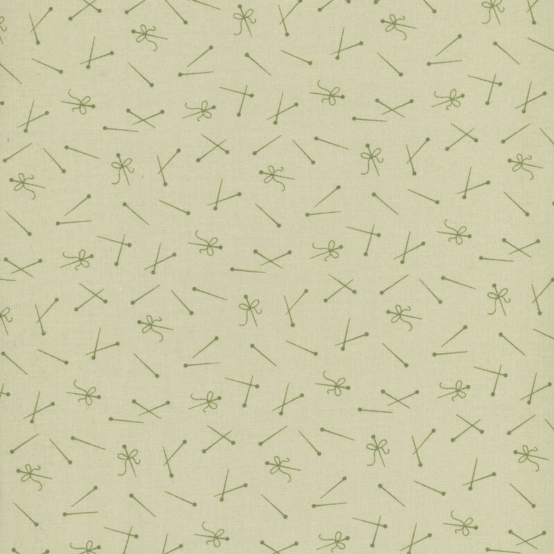 tonal green fabric featuring tossed dark green pins and thread