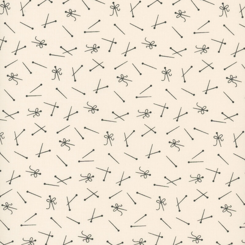 light cream fabric featuring tossed gray pins and thread
