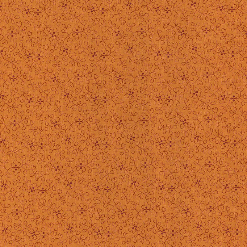 burnt orange fabric with a swirled floral design throughout