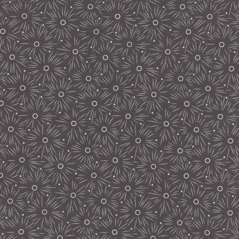 Dark gray fabric with a polka dotted starburst pattern throughout
