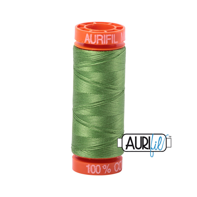 Grass green thread on an orange spool, isolated on a white background