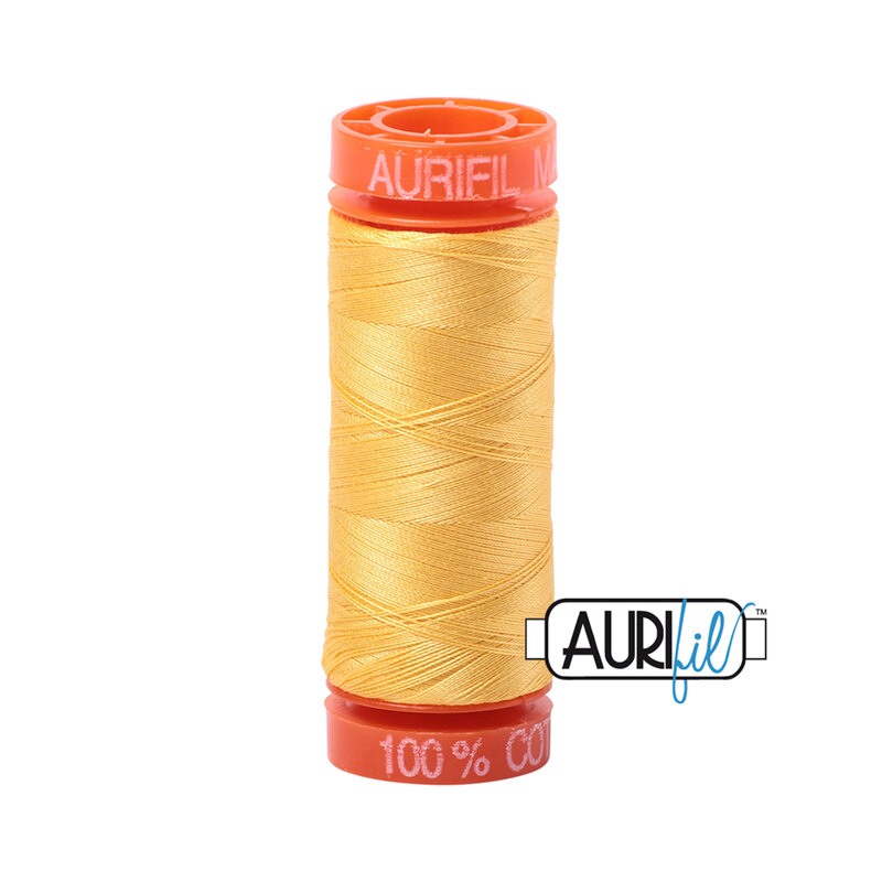 Pale Yellow thread on an orange spool, isolated on a white background