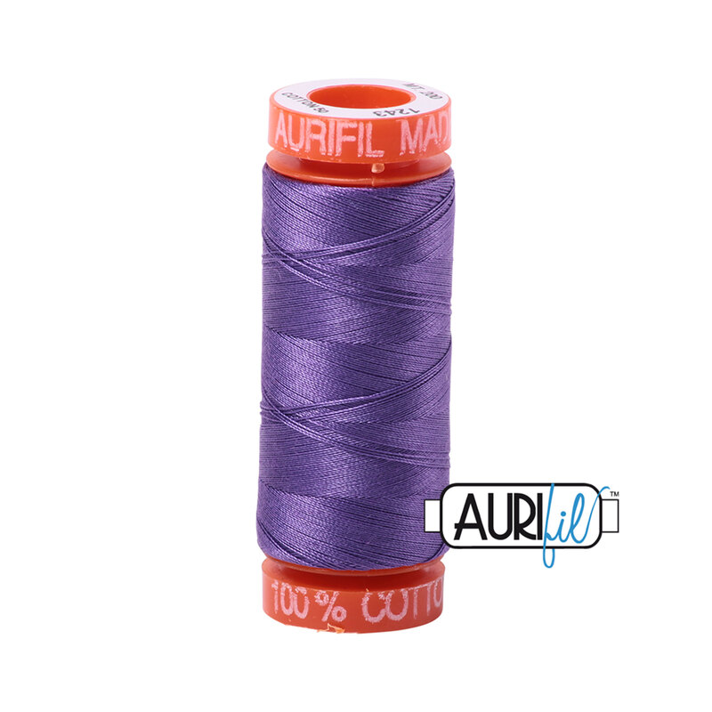 Dusty Lavender thread on an orange spool, isolated on a white background