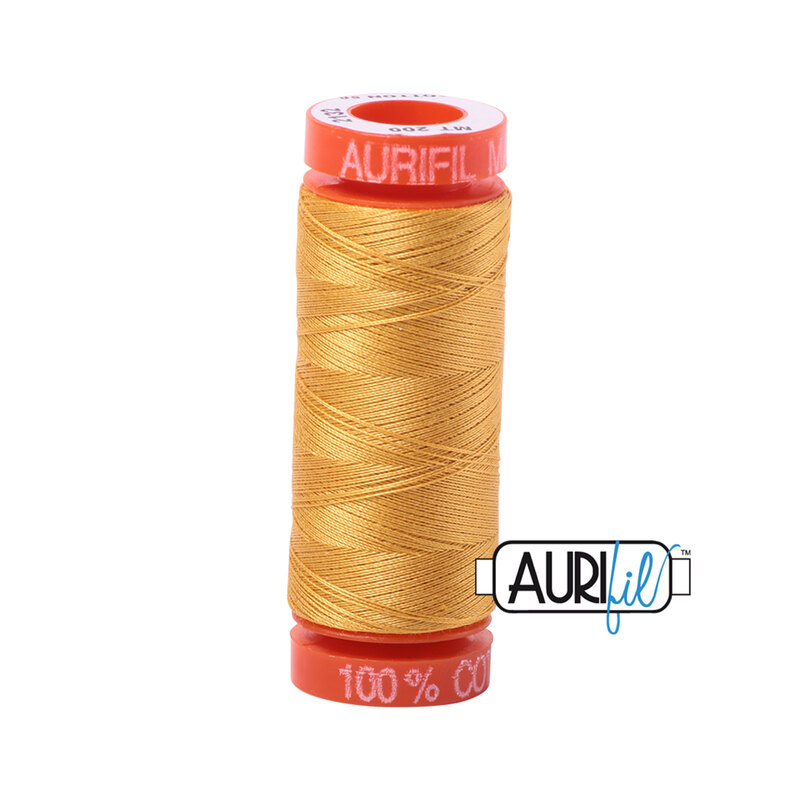Tarnished Gold thread on an orange spool, isolated on a white background