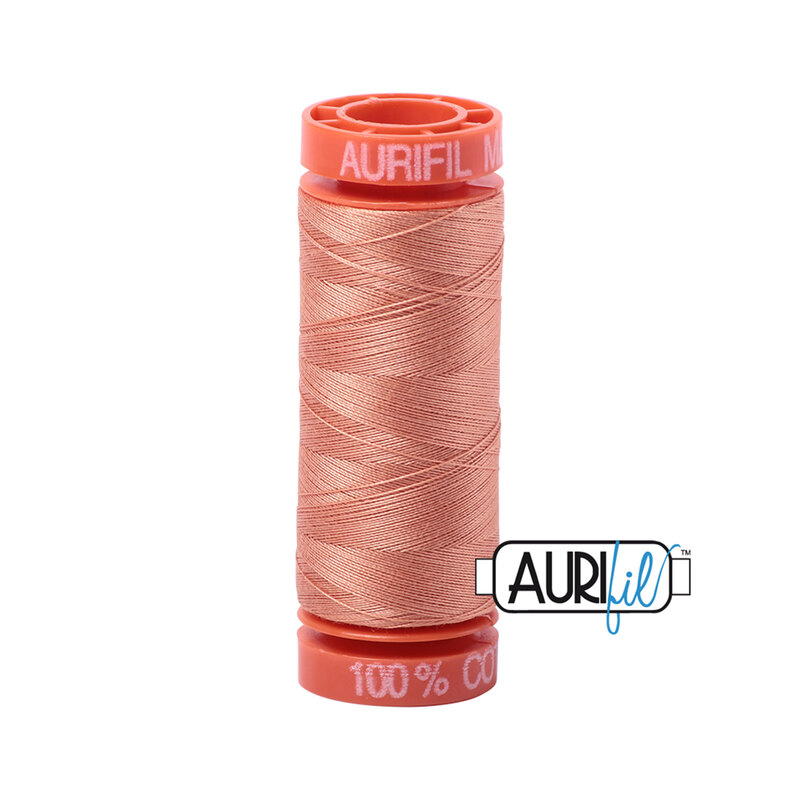 Peach thread on an orange spool, isolated on a white background