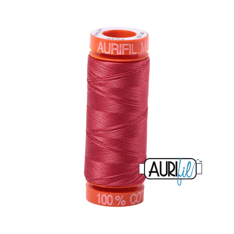 Red Peony thread on an orange spool, isolated on a white background