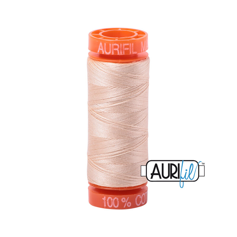 Pale Flesh thread on an orange spool, isolated on a white background