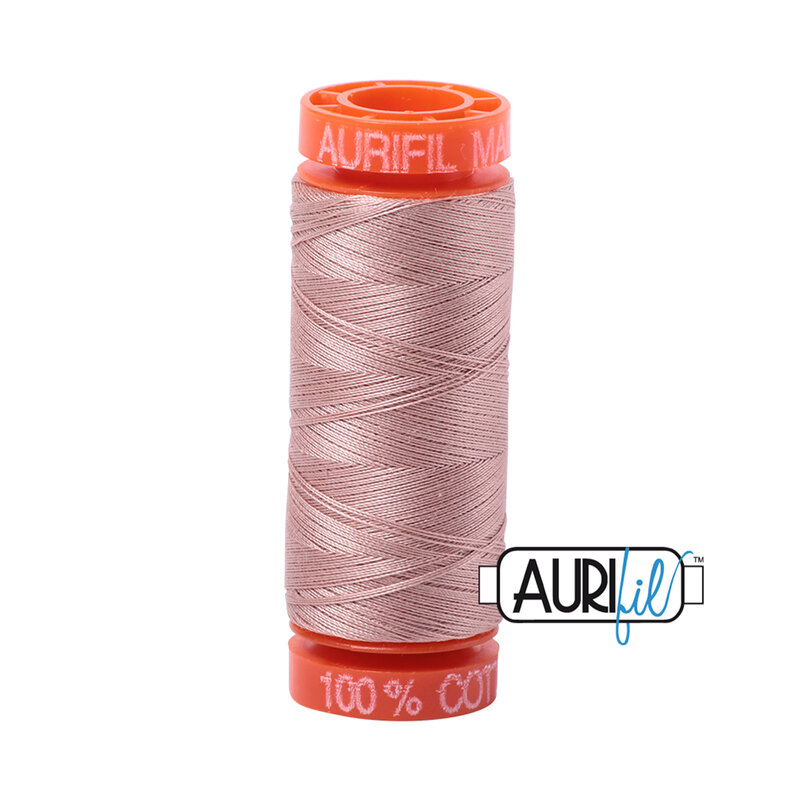 Antique Blush thread on an orange spool, isolated on a white background