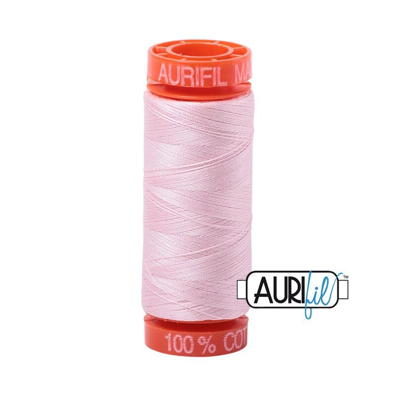 Pale Pink thread on an orange spool, isolated on a white background