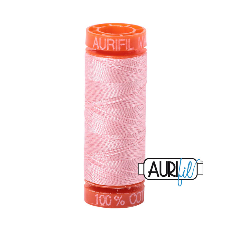 Blush thread on an orange spool, isolated on a white background