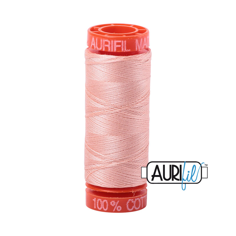 Fleshy Pink thread on an orange spool, isolated on a white background
