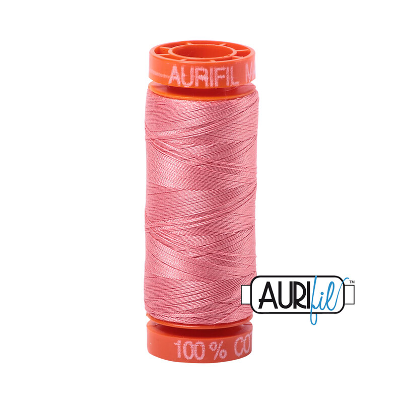 Peachy Pink thread on an orange spool, isolated on a white background