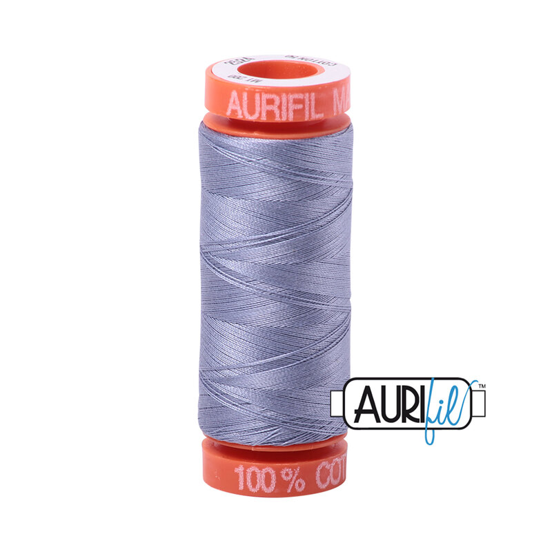 Grey Violet thread on an orange spool, isolated on a white background
