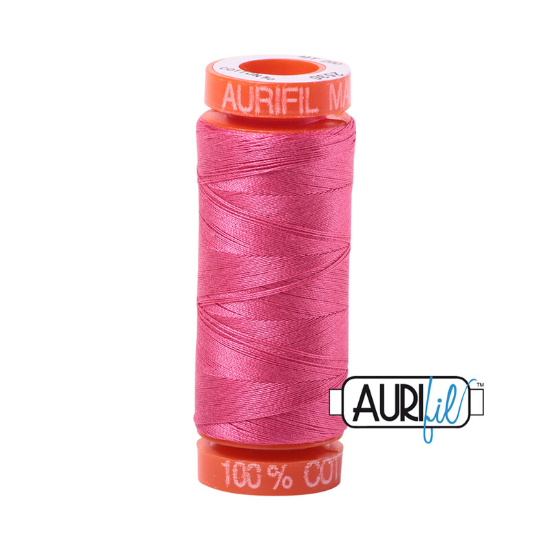 Blossom Pink thread on an orange spool, isolated on a white background