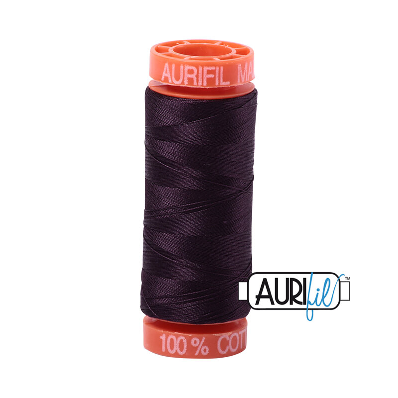 Aubergine thread on an orange spool, isolated on a white background