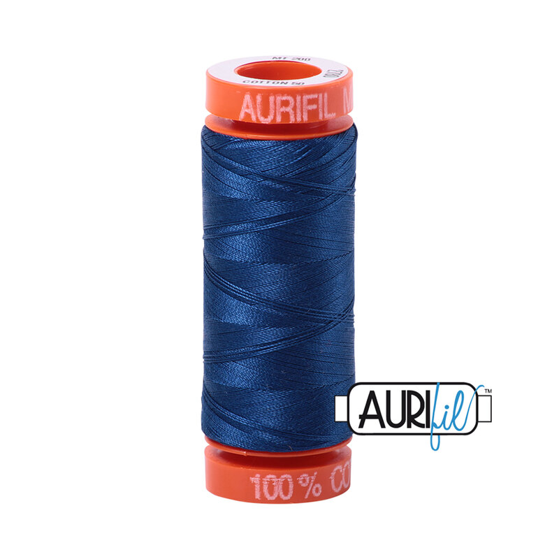 Dark Delft Blue thread on an orange spool, isolated on a white background