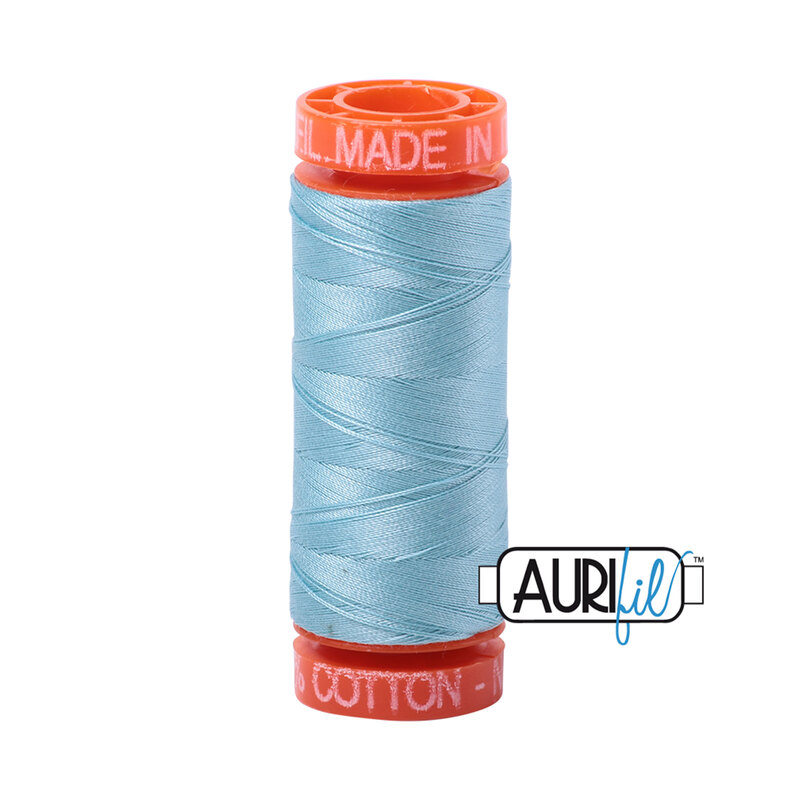 Light Grey Turquoise thread on an orange spool, isolated on a white background