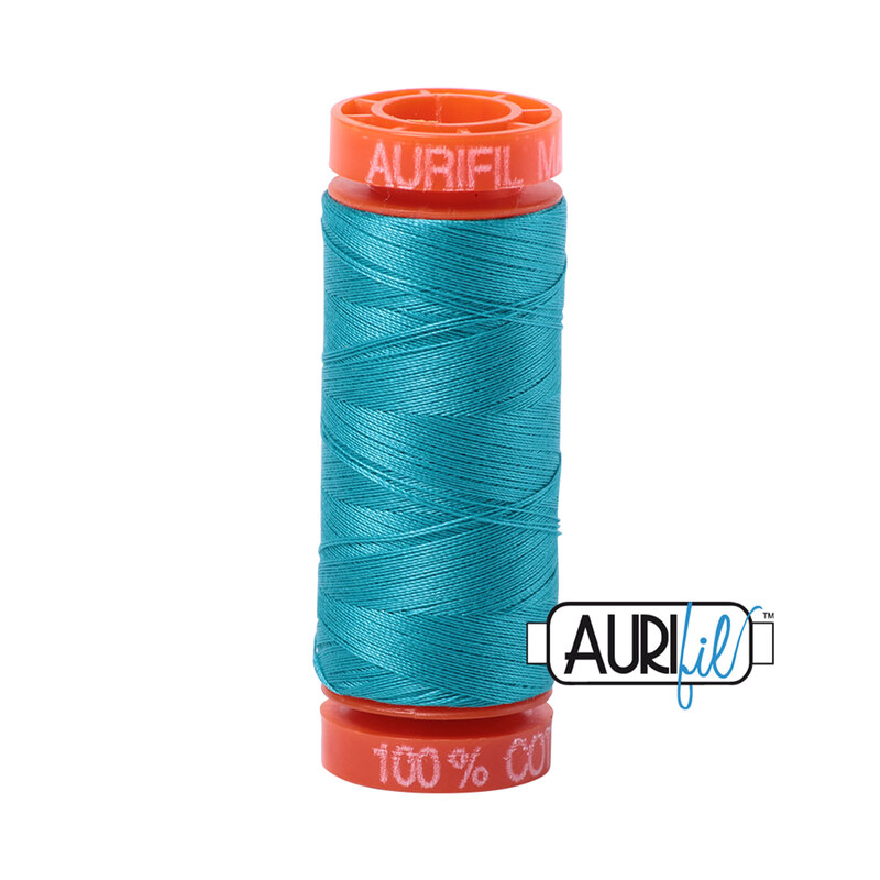 Turquoise thread on an orange spool, isolated on a white background