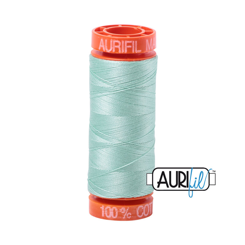 Mint thread on an orange spool, isolated on a white background