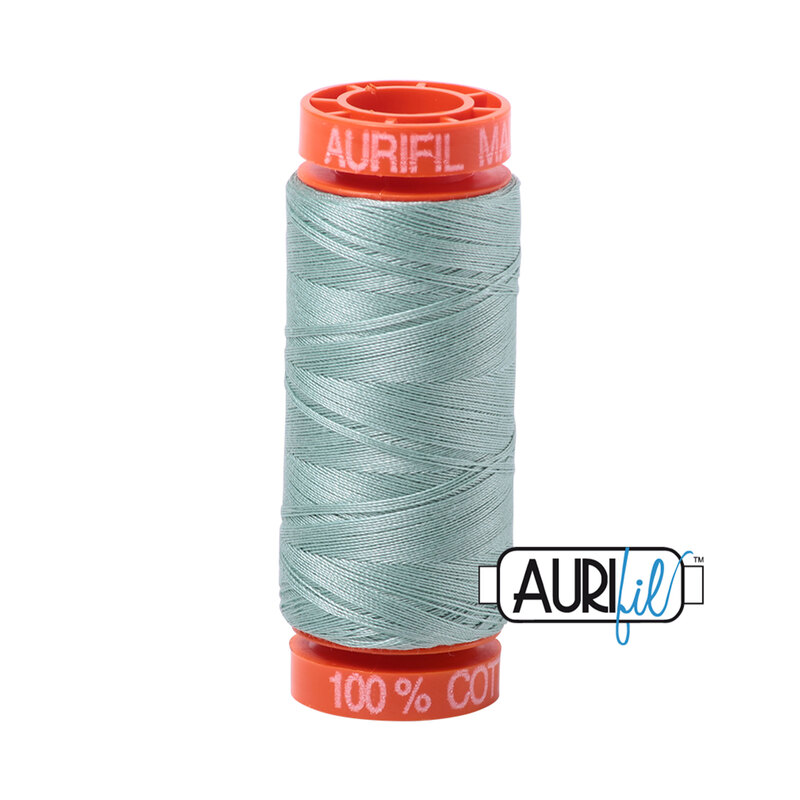 Light Juniper thread on an orange spool, isolated on a white background