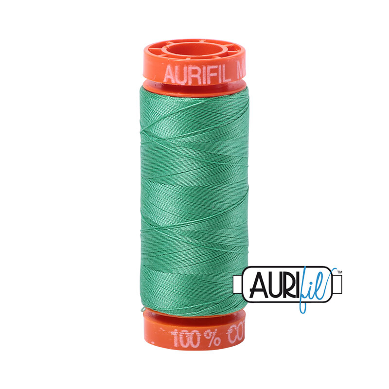 Light Emerald thread on an orange spool, isolated on a white background