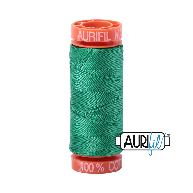 Emerald thread on an orange spool, isolated on a white background