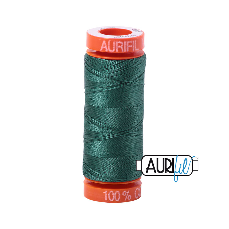 Turf Green thread on an orange spool, isolated on a white background