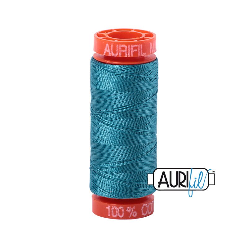 Dark Turquoise thread on an orange spool, isolated on a white background