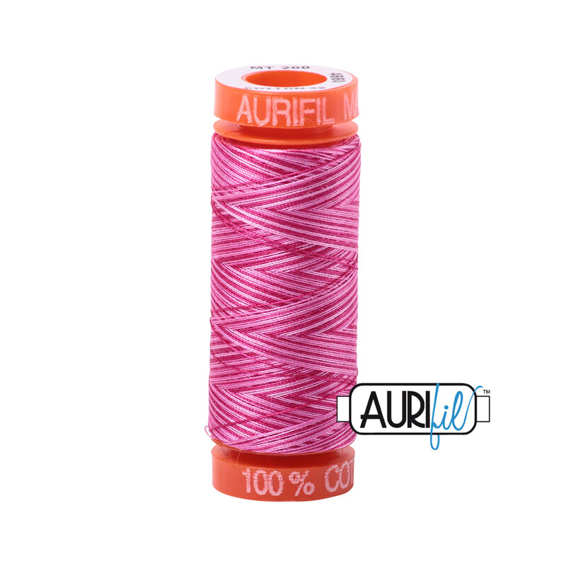 Pink Taffy thread on an orange spool, isolated on a white background